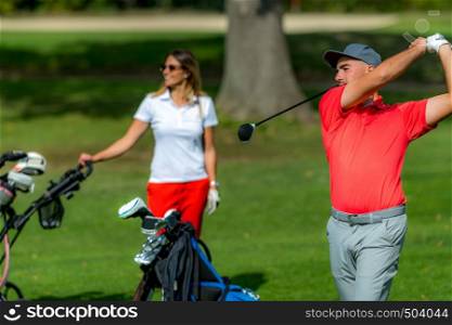 Happy golf couple on a golf course
