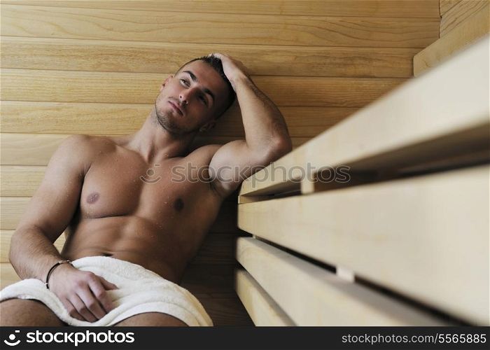 happy good looking and attractive young man with muscular body relaxing in sauna hot