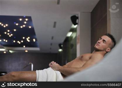 happy good looking and attractive young man with muscular body relaxing in sauna hot