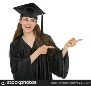 Happy graduation student girl pointing sideways