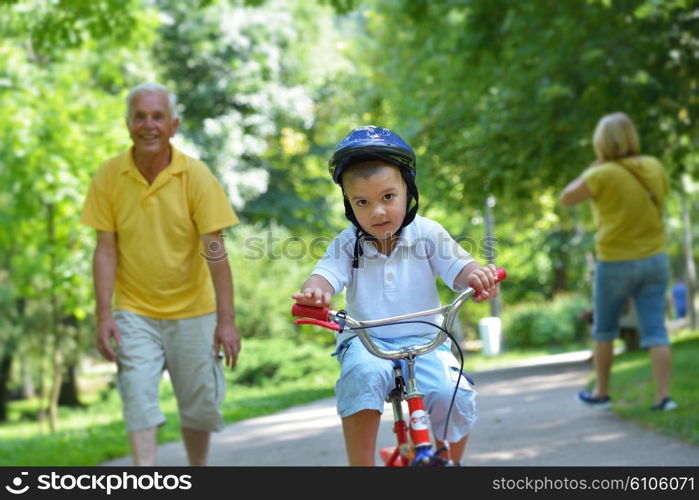 happy grandfather and child have fun and play in park