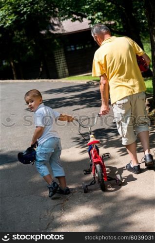 happy grandfather and child have fun and play in park on beautiful sunny day