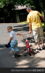 happy grandfather and child have fun and play in park on beautiful sunny day