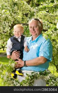 Happy grandfather with his grandson outdoors