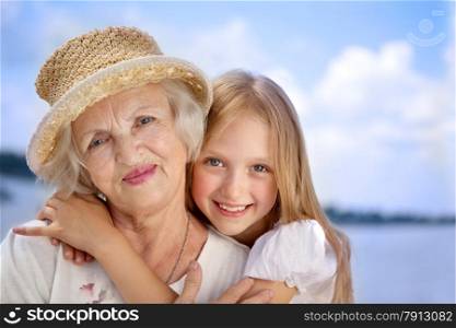 Happy Grandmother and Granddaughter in the Sunny Day.