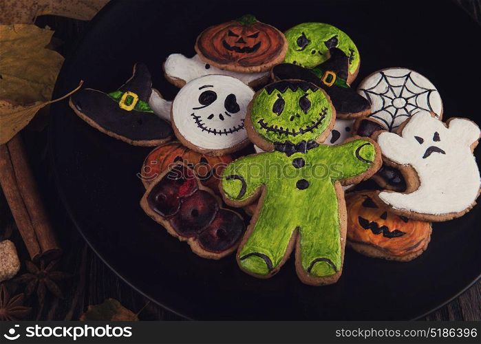 Happy Halloween cookies. Delicious ginger cookies for Halloween on wooden table