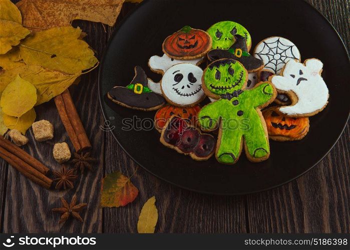 Happy Halloween cookies. Delicious ginger cookies for Halloween on wooden table