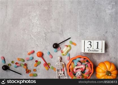 Happy Halloween day with ghost candies, pumpkin,  bowl and 31 October calendar. Trick or Threat, Hello October, fall autumn, Festive, party and holiday concept