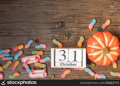 Happy Halloween day with ghost candies, pumpkin,  bowl and 31 October calendar. Trick or Threat, Hello October, fall autumn, Festive, party and holiday concept