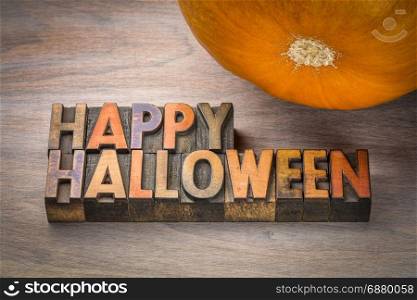 Happy Halloween greeting card - typography in vintage letterpress wood type with a pumpkin
