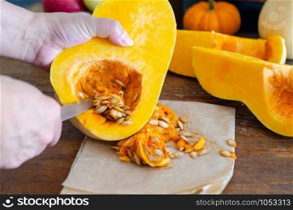 Happy Halloween! Mother is cutting the pumpkin.The woman is preparing for holiday.