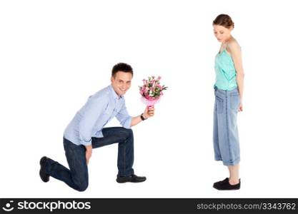 Happy handsome young man handing over a flowers to a beautiful young woman isolated on white