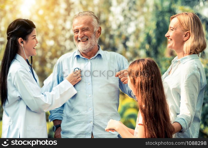 Happy healthy family and doctor talking in the park. People healthcare and medical staff service concept.