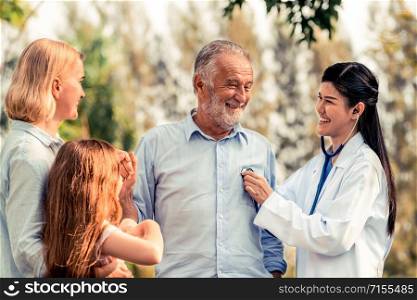 Happy healthy family and doctor talking in the park. People healthcare and medical staff service concept.