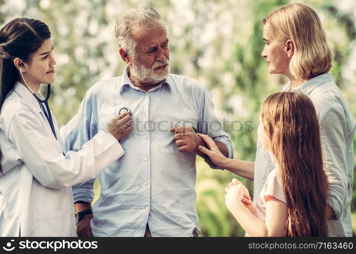 Happy healthy family and doctor talking in the park. People healthcare and medical staff service concept.