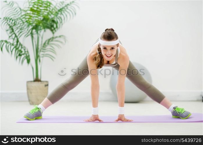 Happy healthy girl doing stretching exercises