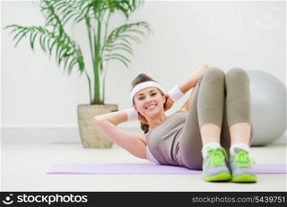 Happy healthy woman doing abdominal crunch
