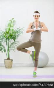 Happy healthy woman doing yoga