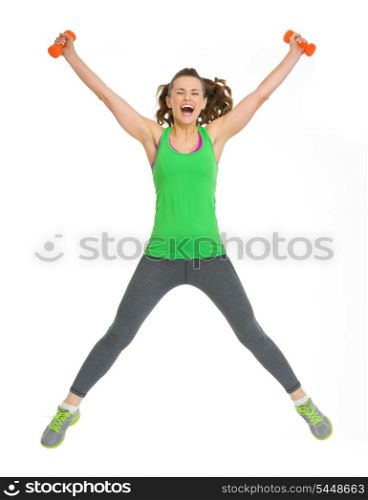 Happy healthy young woman with dumbbells jumping