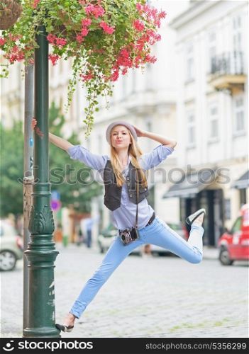 Happy hipster girl having fun on city street
