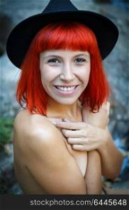 Happy hipster girl in the nature with black hat and without clothes