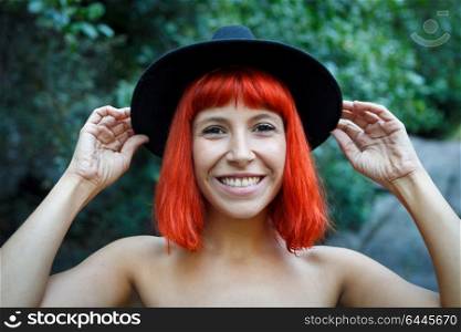 Happy hipster girl in the nature with black hat and without clothes