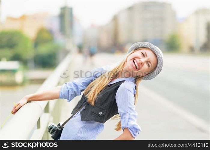 Happy hipster girl on city street