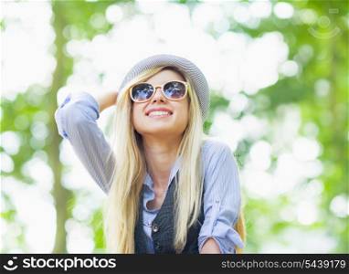 Happy hipster girl rejoicing in the park