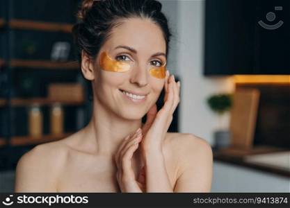 Happy Hispanic girl applying collagen eye patches after bathing. Skincare, relaxation, and beauty routine.