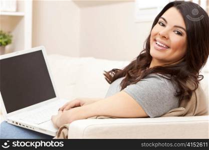 Happy Hispanic Woman Using Laptop Computer at Home