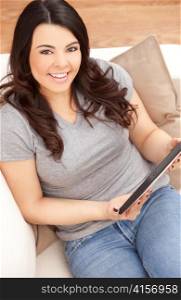 Happy Hispanic Woman Using Tablet Computer At Home