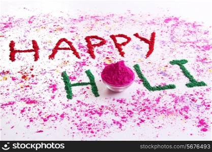 HAPPY Holi written with gulal over white background