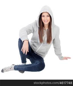 Happy hooded girl with grey sweatshirt sitting on the floor isolated