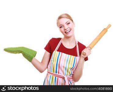 Happy housewife or baker chef wearing kitchen apron green oven mitten holds baking rolling pin showing empty copy space presenting with open hand palm isolated on white