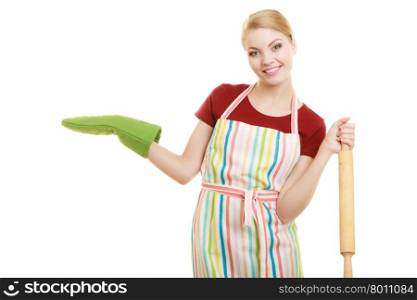 Happy housewife or baker chef wearing kitchen apron green oven mitten holds baking rolling pin showing empty copy space presenting with open hand palm isolated on white