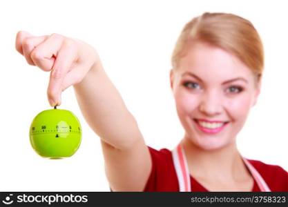 Happy housewife or chef in colorful kitchen showing apple timer eggtimer isolated studio shot