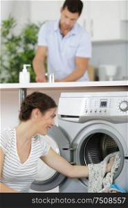 happy housewife woman in laundry room with washing machine