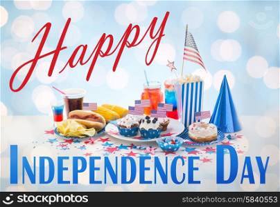 happy independence day, national holidays, celebration, food and patriotism concept - close up of hot dog with american flag decoration, potato chips and drinks on 4th july at home party