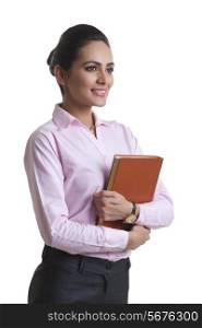 Happy Indian businesswoman holding diary over white background