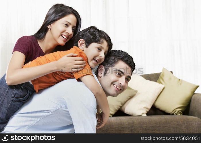 Happy Indian family of three playing at home