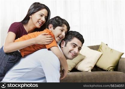 Happy Indian family of three playing at home