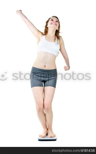 Happy joyful young woman standing on bathroom scale isolated on white
