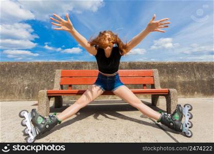 Happy joyful young woman wearing roller skates relaxing after long ride. Girl having fun during summer time near sea.. Joyful girl wearing roller skates