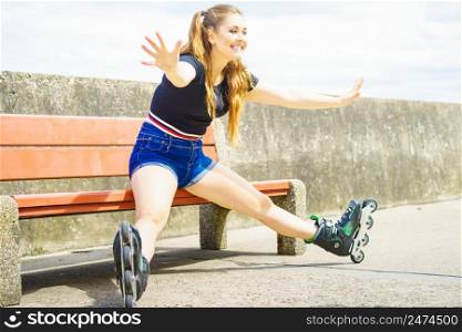 Happy joyful young woman wearing roller skates relaxing after long ride. Girl having fun during summer time.. Joyful girl wearing roller skates
