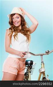 Happy joyful young woman with bike bicycle. Fashionable girl in hat, white shirt and shorts. Summer fashion and recreation. Studio shot.. Woman with bike. Summer fashion and recreation.