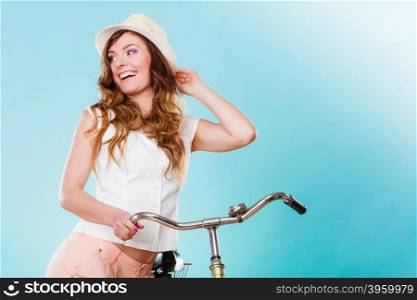 Happy joyful young woman with bike bicycle. Fashionable girl in hat, white shirt and shorts. Summer fashion and recreation. Studio shot.