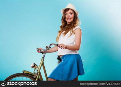 Happy joyful young woman with bike bicycle. Fashionable girl in hat, white shirt and skirt. Summer fashion and recreation. Studio shot.. Woman with bike. Summer fashion and recreation.