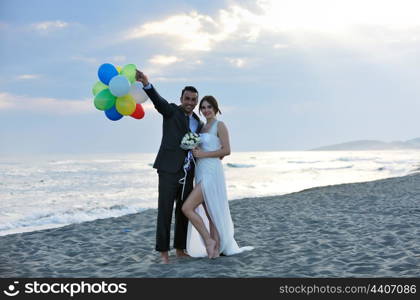 happy just married young couple celebrating and have fun at beautiful beach sunset