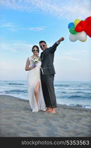 happy just married young couple celebrating and have fun at beautiful beach sunset