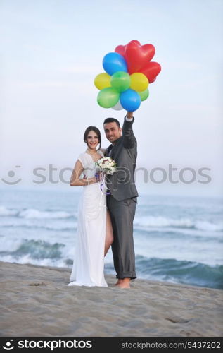 happy just married young couple celebrating and have fun at beautiful beach sunset